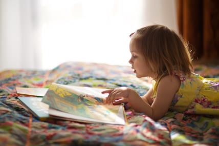 djevojčica čita u krevetu